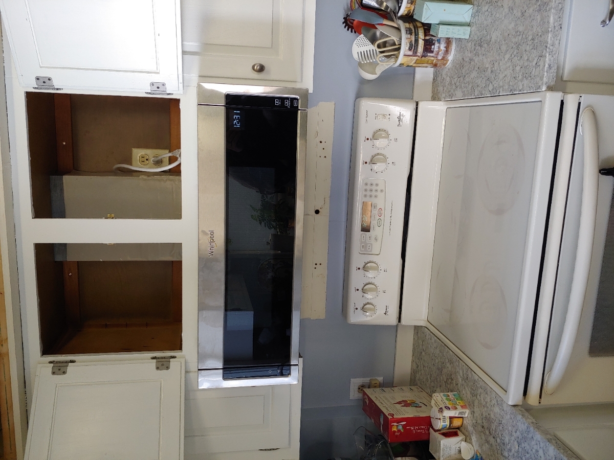 Close-up of appliance components and tools during a professional in-home appliance repair service.